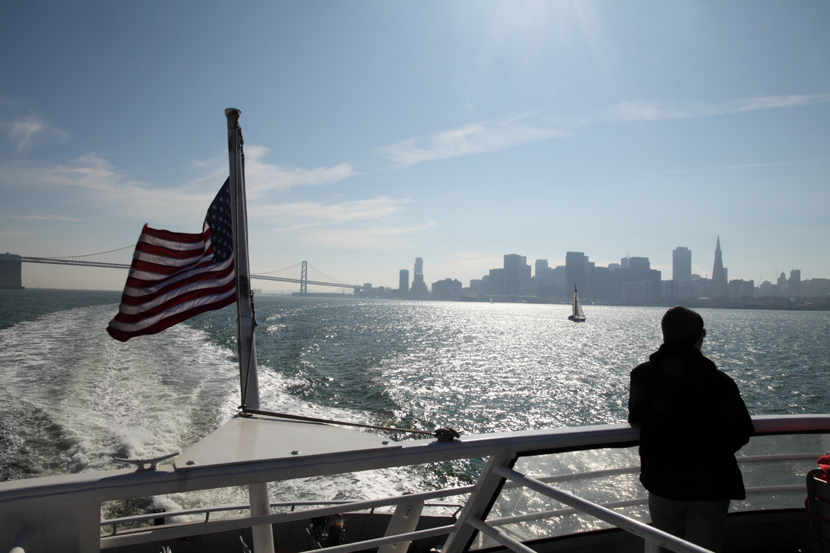 Looking back at the city from the stern of a weekday boat. This is the hour I keep writing about.
